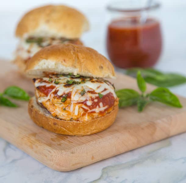 chicken parmesan burgers on a board