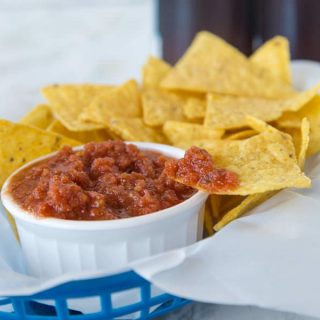 homemade salsa in a white bowl with chips