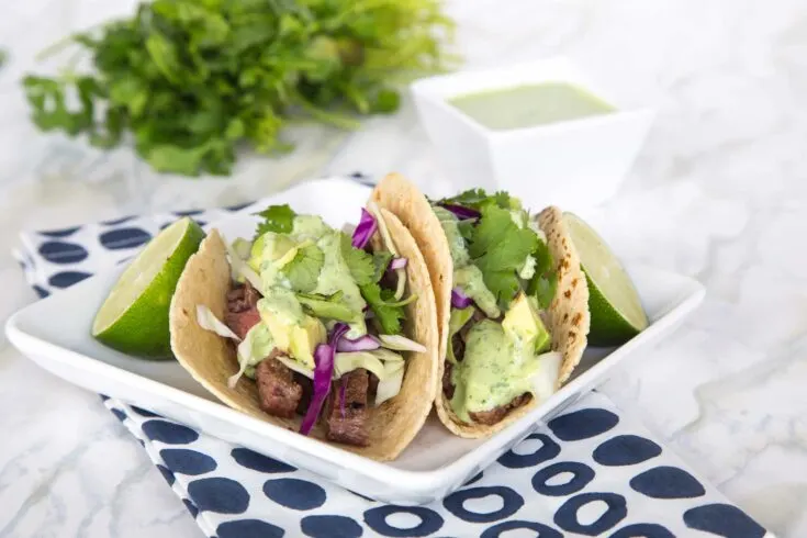 SSteak Street Tacos – tender grilled skirt steak wrapped in a charred corn tortilla and topped with a creamy cilantro lime sauce. Just like Southern California at home in no time!