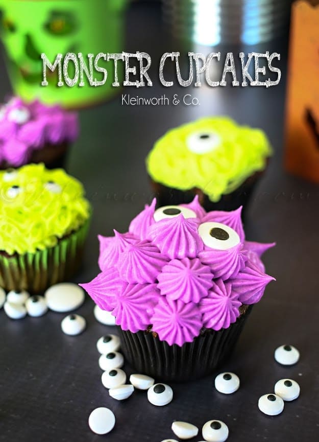 Angled view of monster cupcakes with colorful frosting and candy eyeballs.