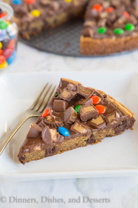 Candy Bar Cookie Pizza - a chocolate chip cookie pizza topped with melted chocolate and lots of your favorite candy!