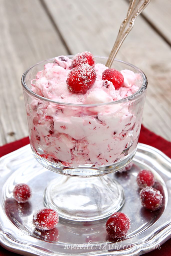 Frozen Cranberry Salad in a glass dish topped with fresh cranberries