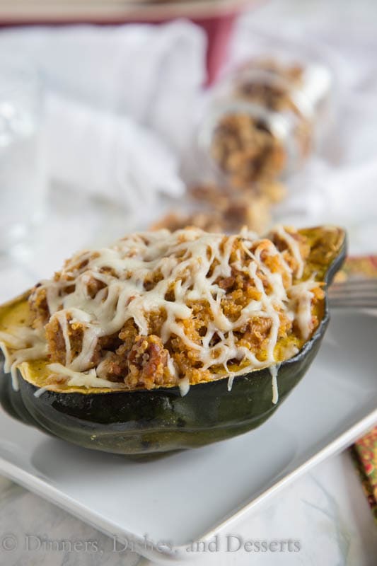 Quinoa and Sausage Stuffed Acorn Squash - Sweet acorn squash stuffed with spicy Italian sausage, quinoa, sweet dried cranberries and walnuts. A perfect fall dinner that can be even be made ahead of time!