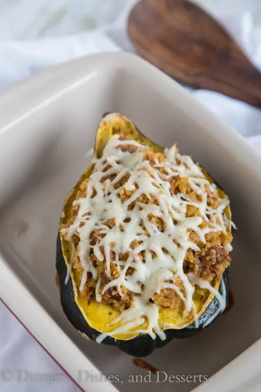 Quinoa and Sausage Stuffed Acorn Squash - Sweet acorn squash stuffed with spicy Italian sausage, quinoa, sweet dried cranberries and walnuts. A perfect fall dinner that can be even be made ahead of time!
