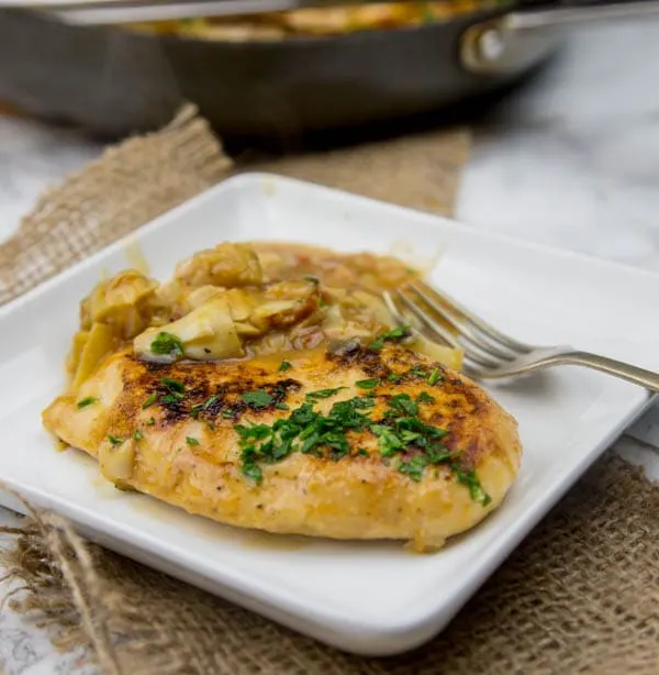Chicken in Artichoke Pan Sauce - sauteed chicken breasts in a creamy artichoke pan sauce. Ready in minutes and perfect for weeknights!