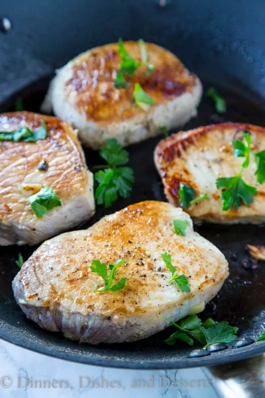 Lemon Garlic Pork Chops - Thick pork chops marinated in lemon and garlic, and then seared to perfection. Lots of flavor, and super juicy pork chops in minutes!