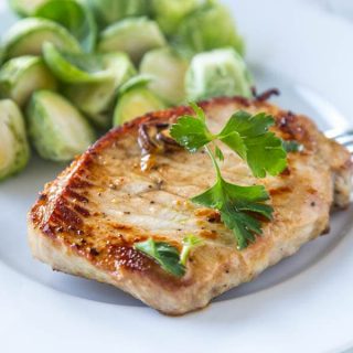 Lemon Garlic Pork Chops - Thick pork chops marinated in lemon and garlic, and then seared to perfection. Lots of flavor, and super juicy pork chops in minutes!