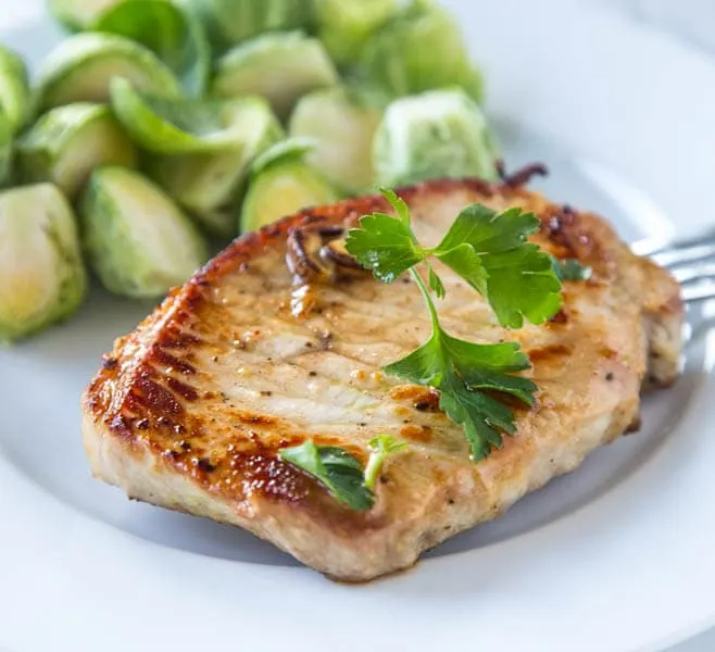 Lemon Garlic Pork Chops - Thick pork chops marinated in lemon and garlic, and then seared to perfection. Lots of flavor, and super juicy pork chops in minutes!