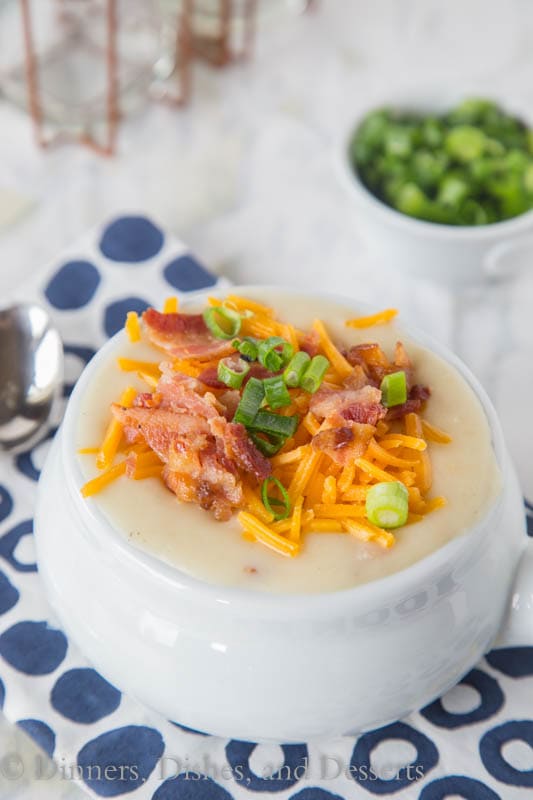 potato soup in a bowl with bacon, cheese, and onions