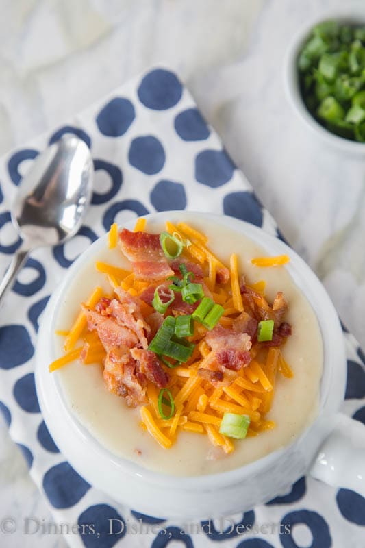 potato soup in a bowl with bacon, cheese, and onions