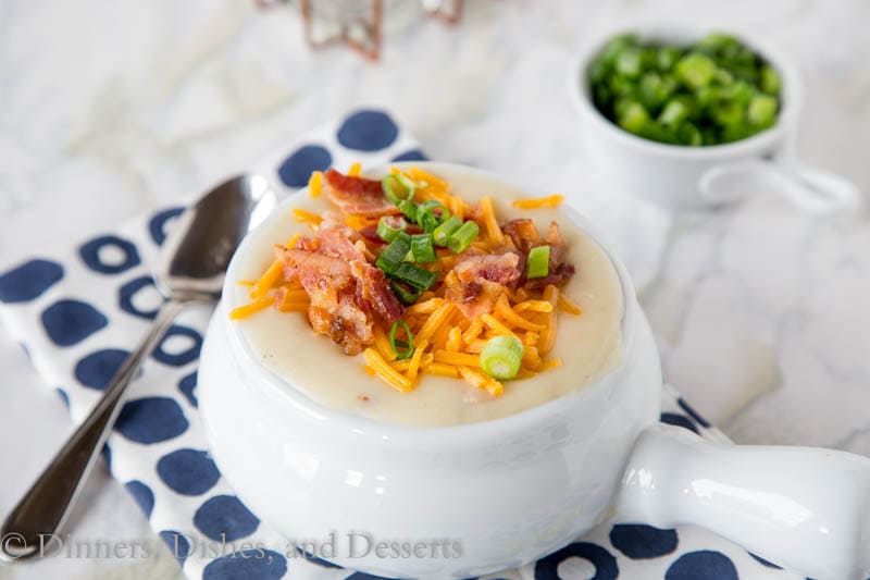 potato soup in a bowl with bacon, cheese, and onions