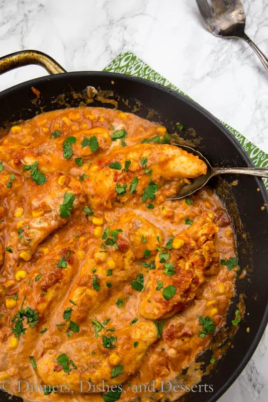 Creamy Salsa Chicken - Taco spiced chicken cooked with corn and salsa, and sour cream mixed into make it creamy and delicious! One pan and 20 minutes!