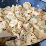 Tomato-Basil Pasta - a rich and creamy pasta dinner the whole family will love. Ravoili or Tortellini tossed in a sun-dried tomato cream sauce and plenty of fresh basil!