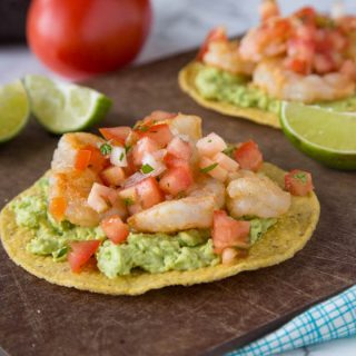 Shrimp & Avocado Tostadas - a fun and easy way to get Mexican food on weeknights, in minutes! Crispy tostadas topped with guacamole, spiced shrimp, and your favorite salsa.