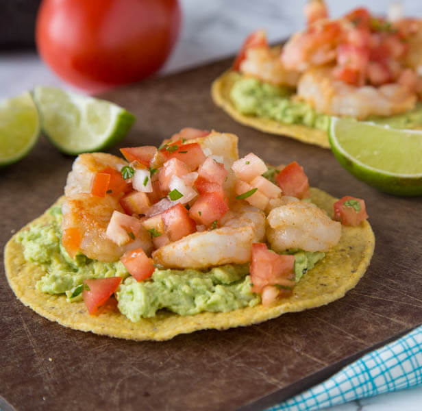 Shrimp & Avocado Tostadas - a fun and easy way to get Mexican food on weeknights, in minutes! Crispy tostadas topped with guacamole, spiced shrimp, and your favorite salsa.