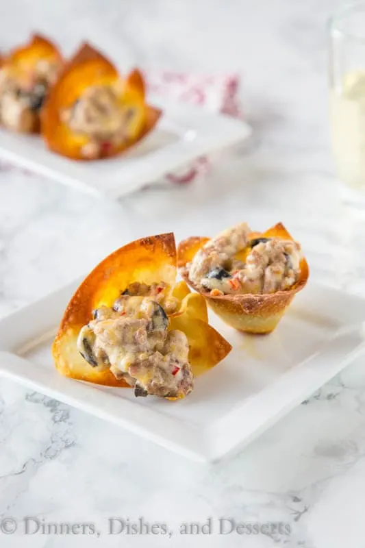 baked wonton cups with sausage and cheese on a plate
