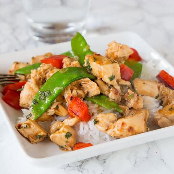 Spicy Basil Chicken - get dinner on the table in just minutes with the super easy chicken recipe. Great Asian flavors with just a little kick. Add veggies to make it a complete meal!
