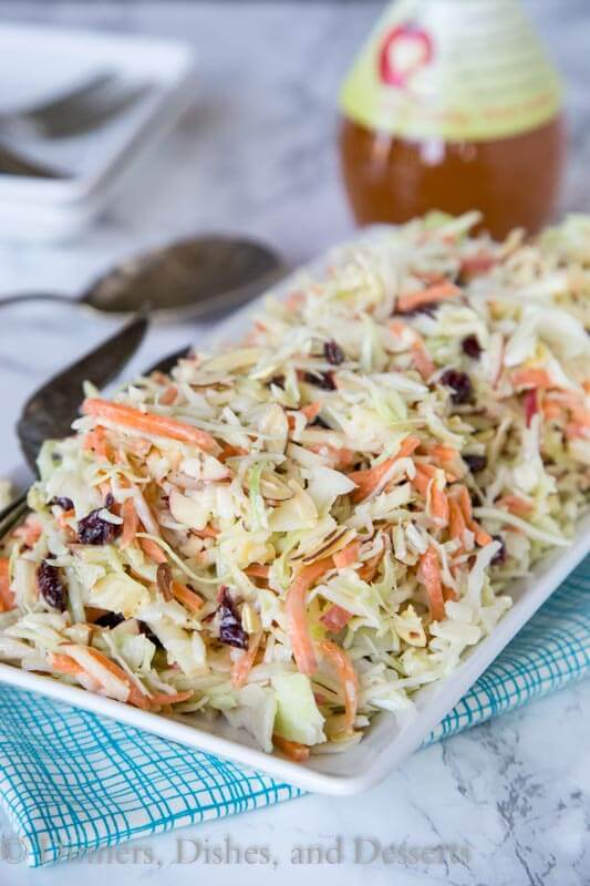 A close up of a plate of food, with Coleslaw and Cabbage