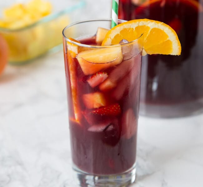 This Easy Sangria Recipe will definitely be a hit at any get together. Slightly sweet, fruity, and perfect for a hot day. Make a pitcher today and invite some friends over!