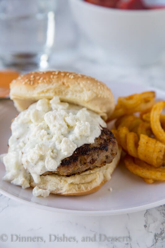 Greek Turkey Burgers - a great way to have burger night with a delicious twist! Greek flavored turkey burgers topped with tzatziki sauce and feta cheese!