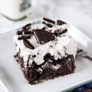 Oreo Poke Cake - An easy chocolate cake topped with an Oreo pudding and whipped cream mixture. Light, creamy, and so good!