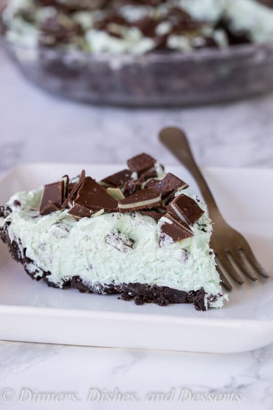 No Bake Mint Chocolate Chip Pie - a creamy mint pie with chocolate chips, topped with Andes mints, all in an Oreo crust! Such an easy no bake recipe for those hot days.