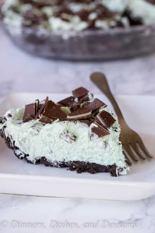 No Bake Mint Chocolate Chip Pie - a creamy mint pie with chocolate chips, topped with Andes mints, all in an Oreo crust! Such an easy no bake recipe for those hot days.