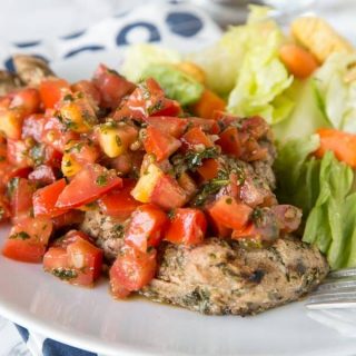 Bruschetta Chicken - chicken marinaded and grilled, then topped it tomato and garlic bruschetta. Healthy, quick, easy, and delicious!