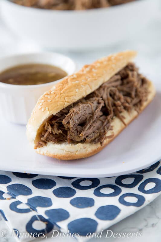 Slow Cooker French Dip Sandwich - Just 4 ingredients to make these super tender and delicious French dip sandwiches. They cook in the crock pot all day, so dinner is waiting for you!