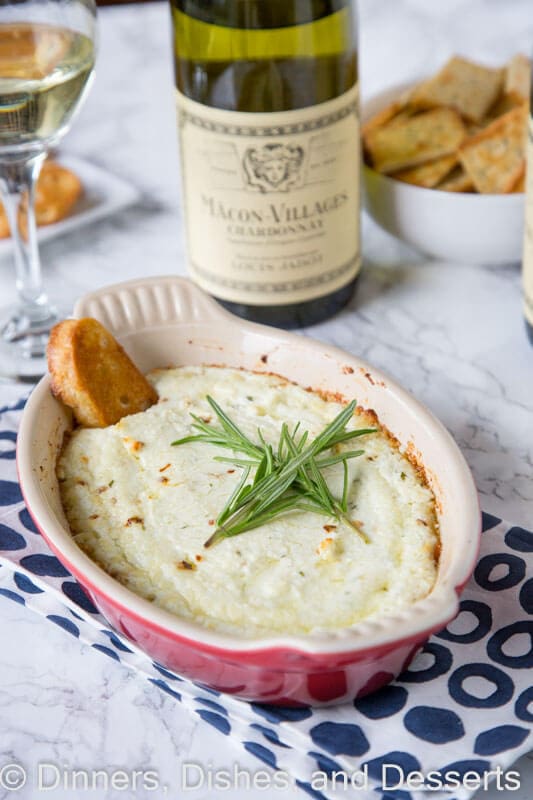 Baked Goat Cheese Dip with Garlic and Herbs - melty, cheesy baked goat cheese dip with lots of garlic and herbs! Pair with a glass of wine and you have the perfect appetizer.