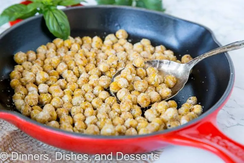 chickpeas in a skillet with a spoon
