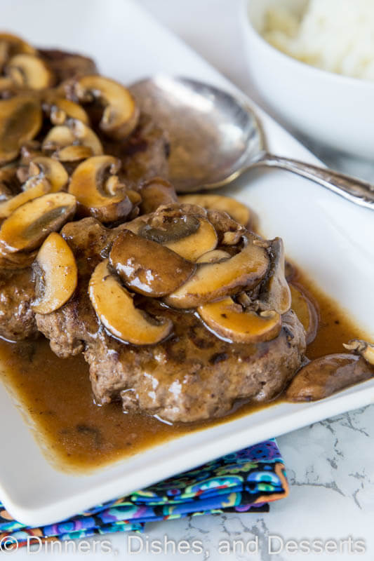 Hamburger Steaks with Mushroom Gravy -easy comfort food that won't break the bank! Rich mushroom gravy over tender hamburger steaks is a great weeknight dinner.