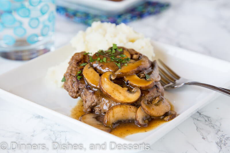 A plate of food with a fork, with Steak and Hamburger