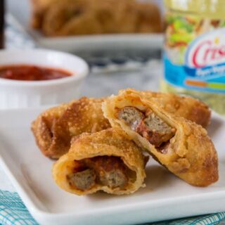 Meatball Sub Egg Rolls - all the flavors of your favorite meatball sub sandwich in a crispy egg roll. Serve with marinara sauce for dipping and you have the perfect appetizer or snack!