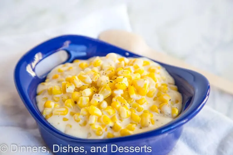 A bowl of food on a plate, with Dinner and Creamed corn