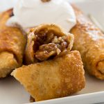 Pecan Pie Egg Rolls - instead of traditional pecan pie, turn it into something fun. Gooey pecan pie filling inside of a crispy egg roll and topped with whipped cream!