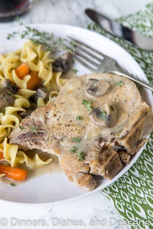 slow cooker pork chops on a plate with other food