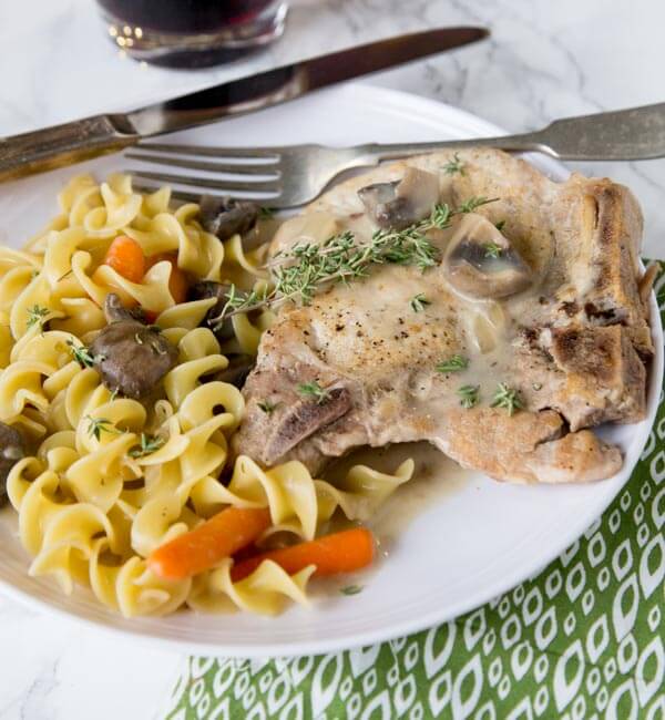 Slow Cooker Pork Chops - use bone in pork chops in the slow cooker for an easy dinner. Add some veggies, and you have a complete meal waiting for you at dinner time!