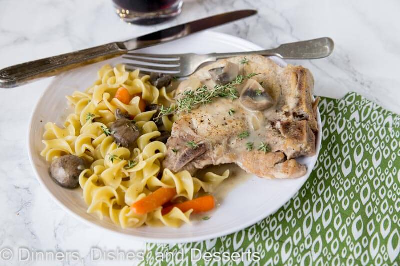 slow cooker pork chops on a plate with other food