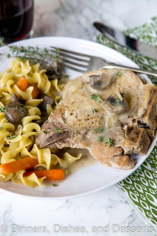 slow cooker pork chops on a plate with other food