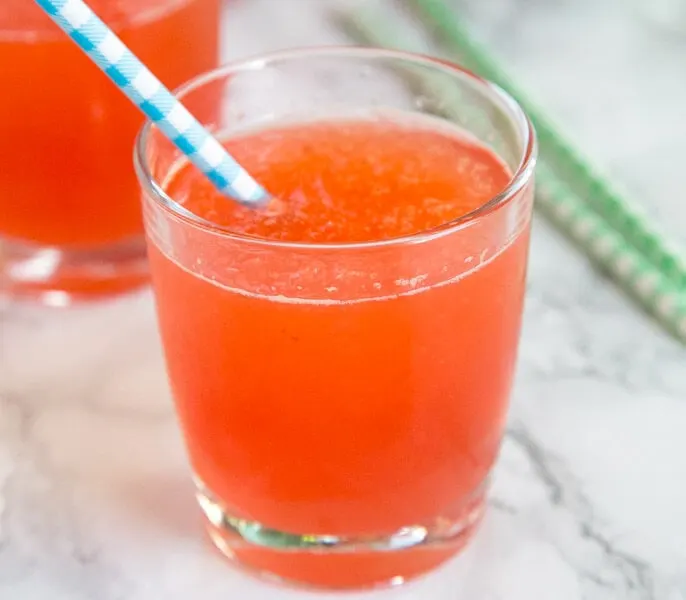 Icy holiday punch in a cup with a straw