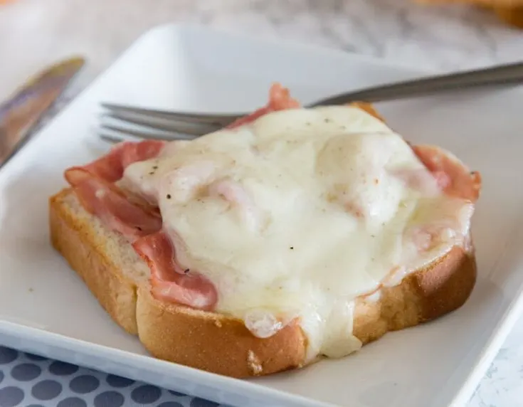 open faced croque monsieur on a plate
