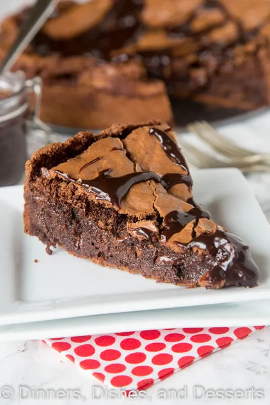 Gooey Brownie Pie - a gooey chocolate brownie with a crackly top baked into a pie and topped with hot fudge. A delicious and easy dessert for any chocolate lover.