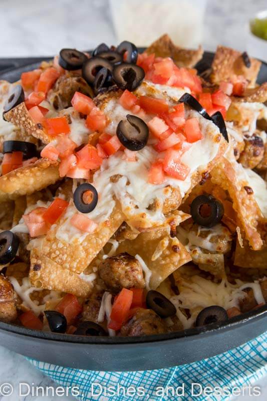 close up of Italian nachos with sausage in a bowl