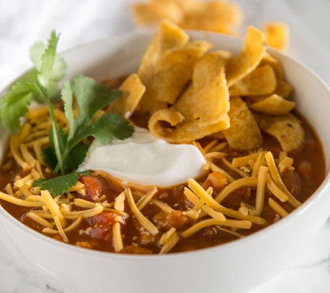 Easy Taco Soup - a hearty and comforting taco flavored soup that is ready in minutes. Top with your favorite toppings to make it even better!