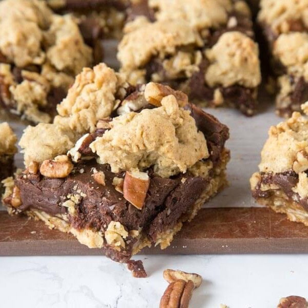 Fudge Nut Bars - an oatmeal cookie base topped with chocolate fudge, lots of nuts, and then more oatmeal cookie baked on top! Gooey and so good!