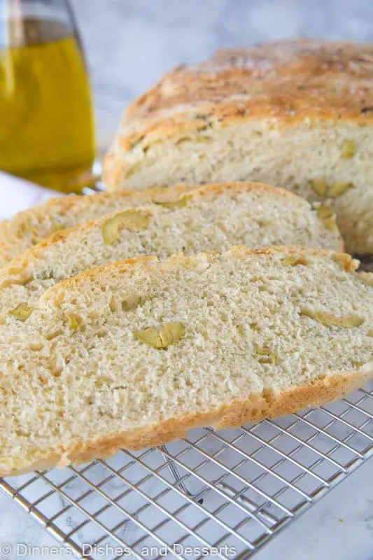 A piece of bread on a plate, with Olive and No-knead bread