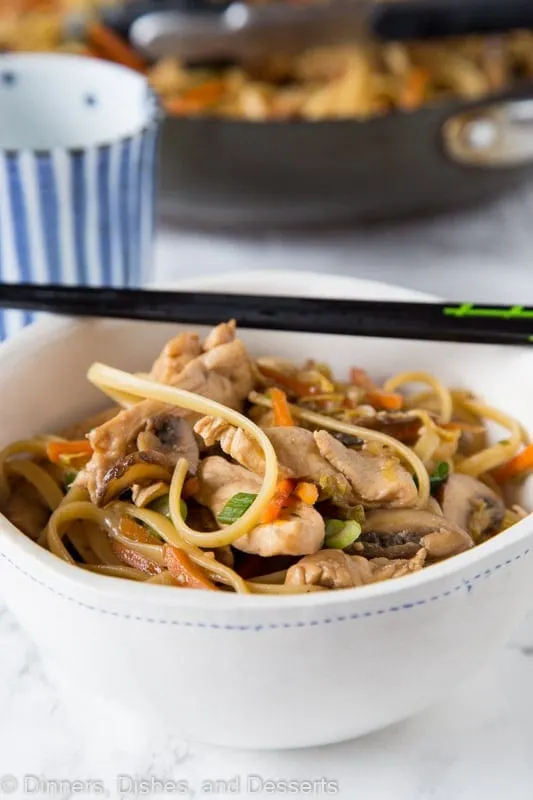 chicken lo mein in a bowl with chopsticks