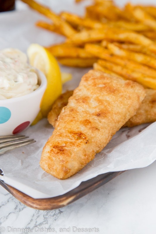 A plate of food, with Tartar sauce and Fish and chips