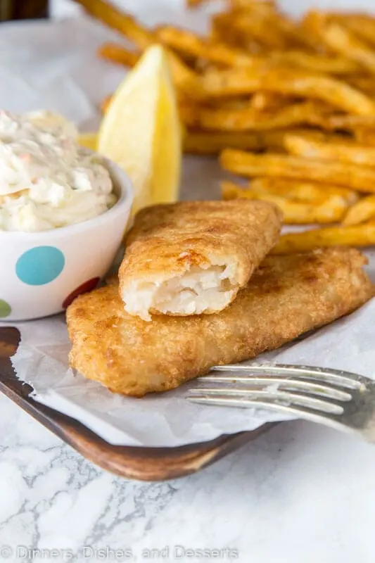 A plate of food, with Tartar sauce and Fish and chips